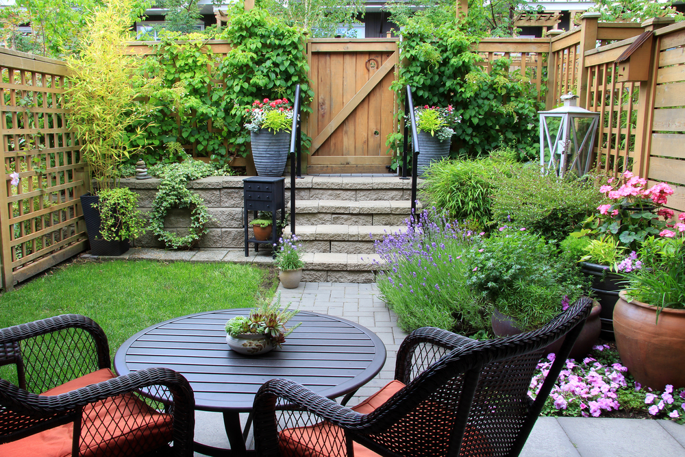 Small,Townhouse,Garden,With,Patio,Furniture,Amidst,Blooming,Lavender.